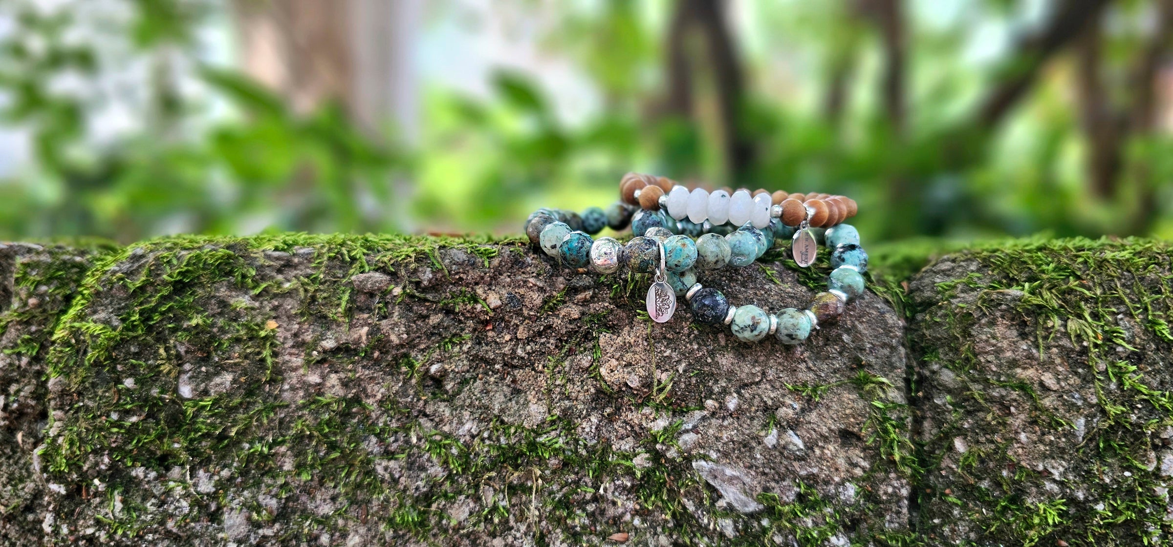 Gemstone Bracelets on Moss Stone Wall - R.B. Amber Jewelry